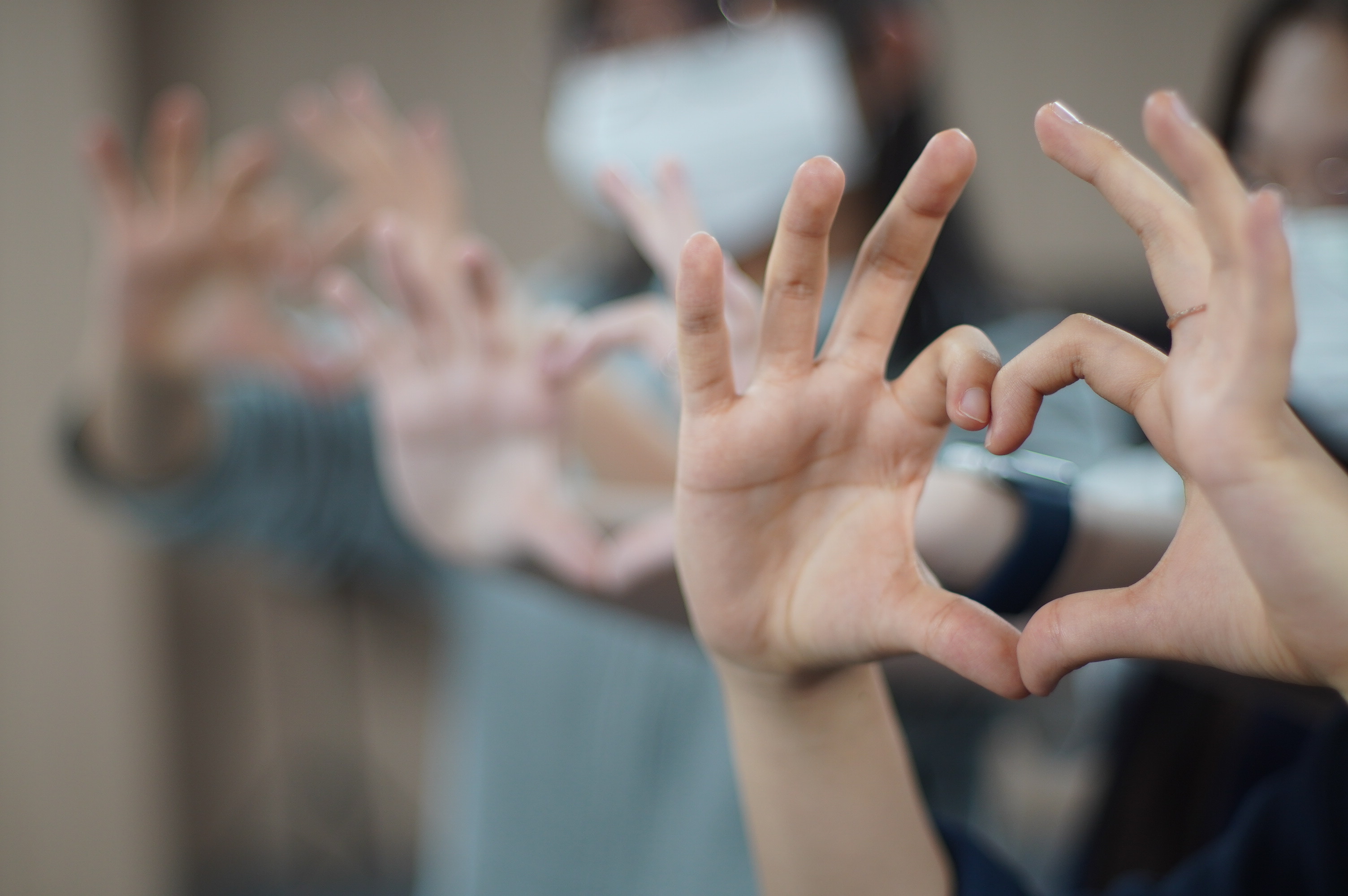 Happy guests making heart shapes with their hands on Ella's Hanoi Food Tour