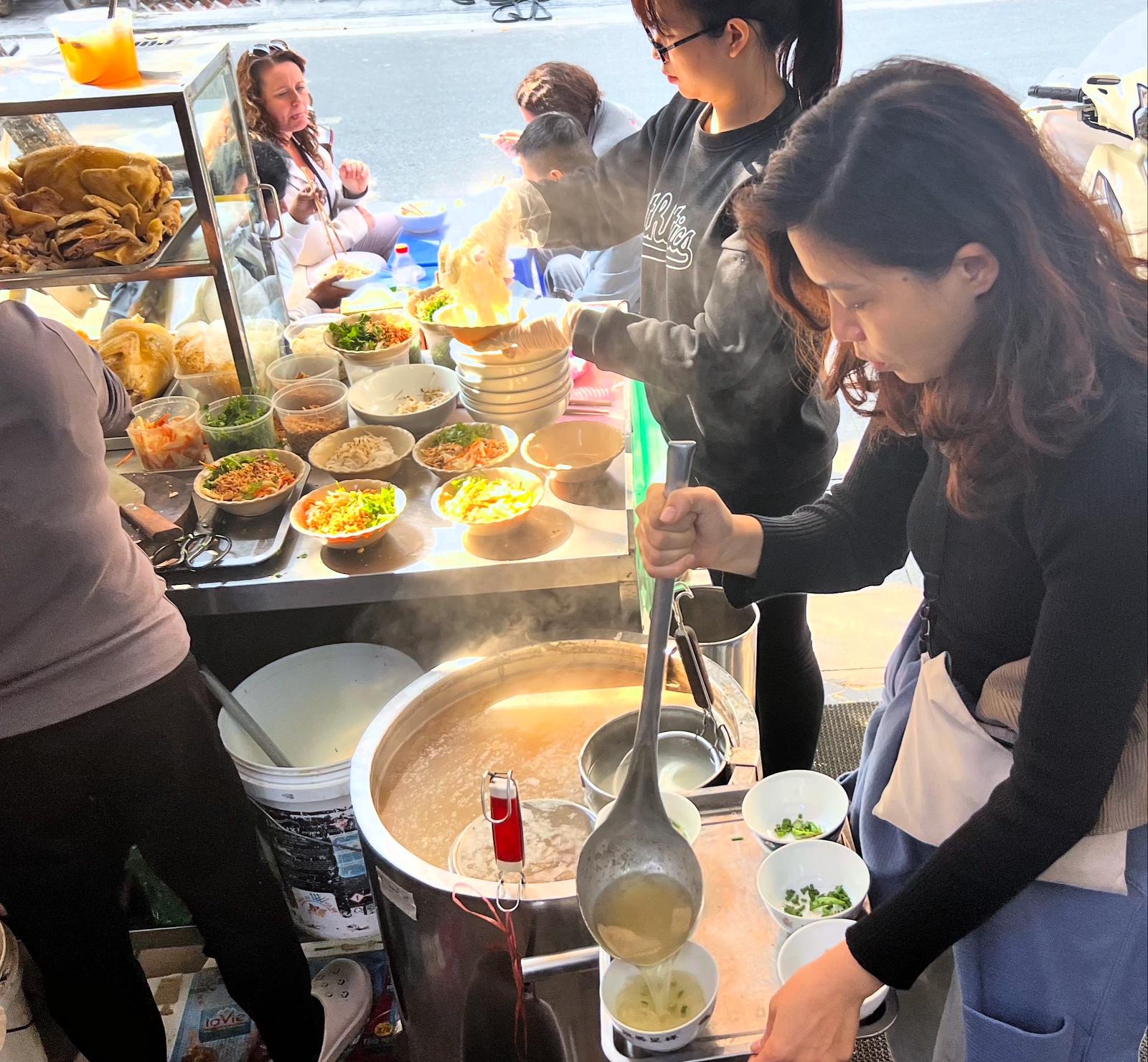 Learning to serve pho at a Hanoi street stall