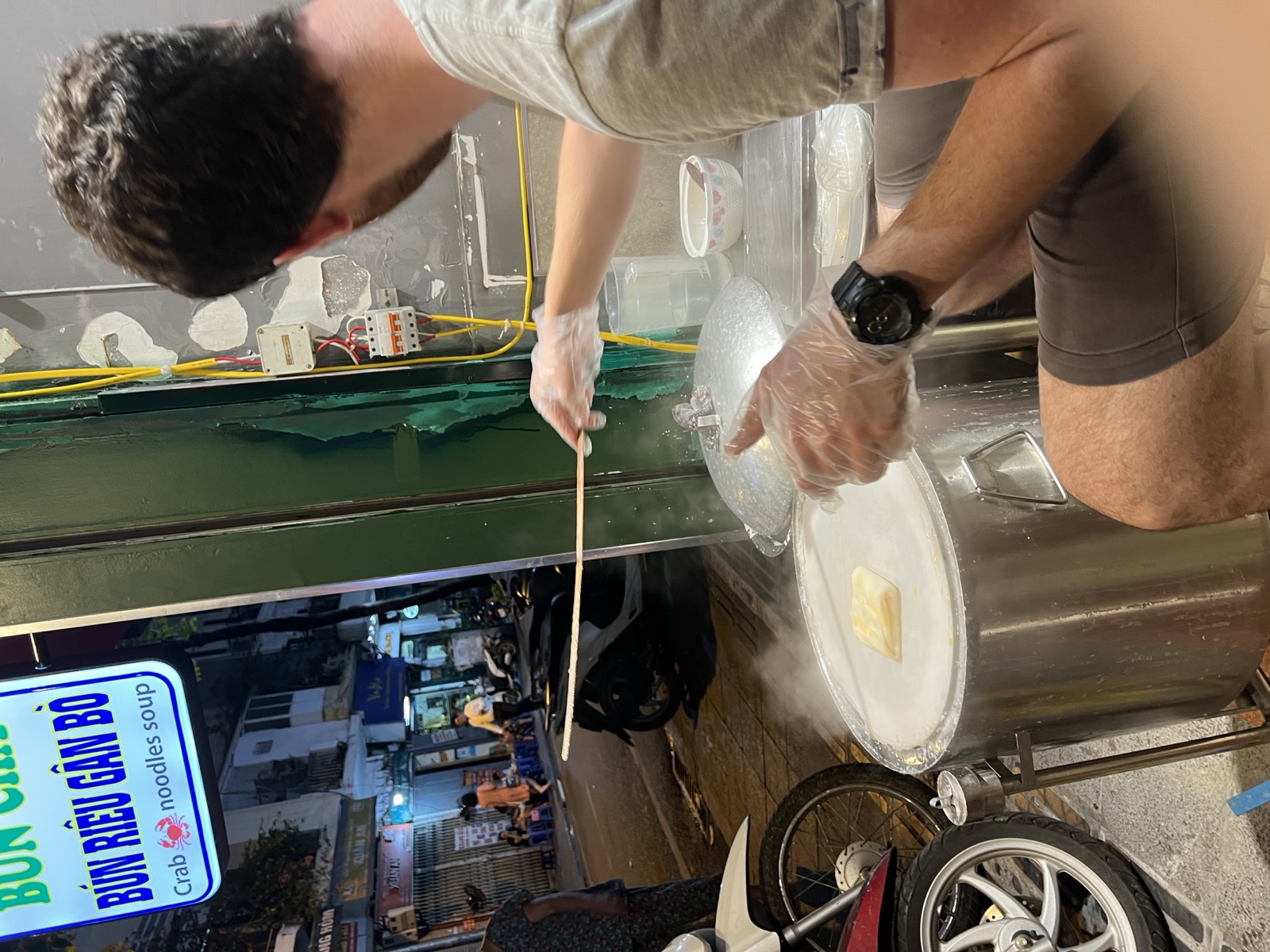 Making fresh rice noodles at a Hanoi street stall